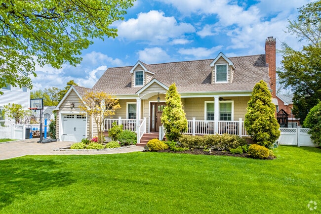 A porch on this cape in Manhasset Hills invites outdoor relaxation.