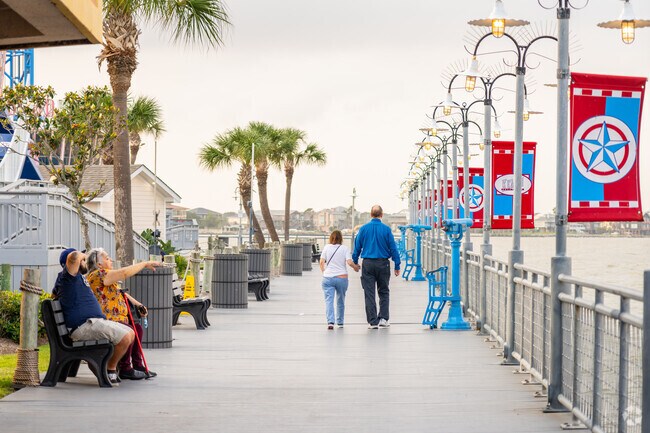 Couples can be seen enjoying a Stroll on The Kemah Boardwalk.