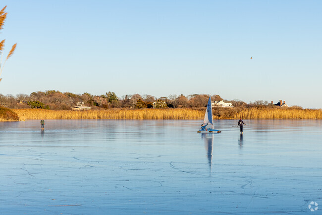 East Gloucester residents skate and wind sail on a frozen lakes during the winter.