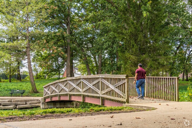 A Fairview Park visitor walks across the pond bridge a short drive from Fairlawn.