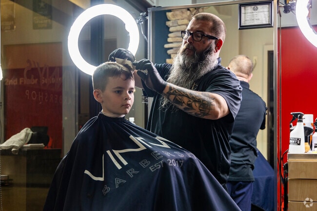 A boy gets a fresh cut at Vinny's Barber Shop in the Portofino Shopping Center in Shenandoah.