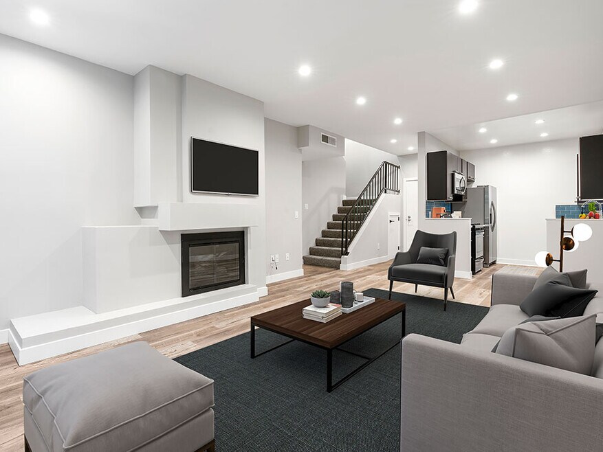 Living Room with hardwood floors, fireplace, and access to upper floor.