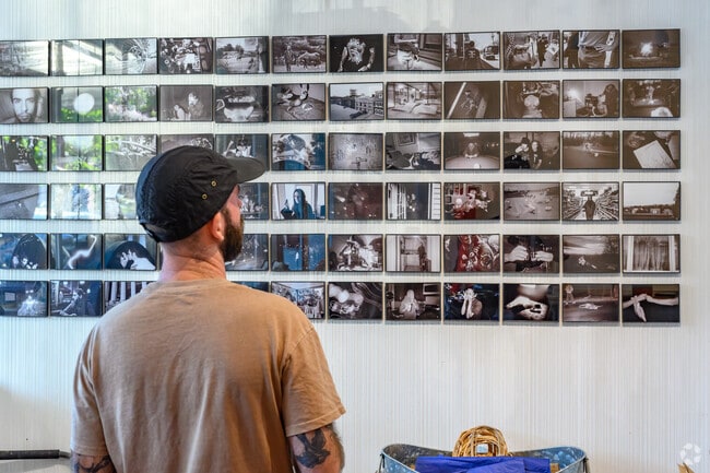 Artist Tyler Magee prepares his exhibit at Knaus Wine Bar & Gallery in Highland.