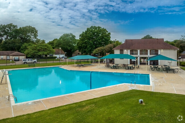 Northwest Park Community Pool is a large pool with covered seating areas and a kiddie pool.