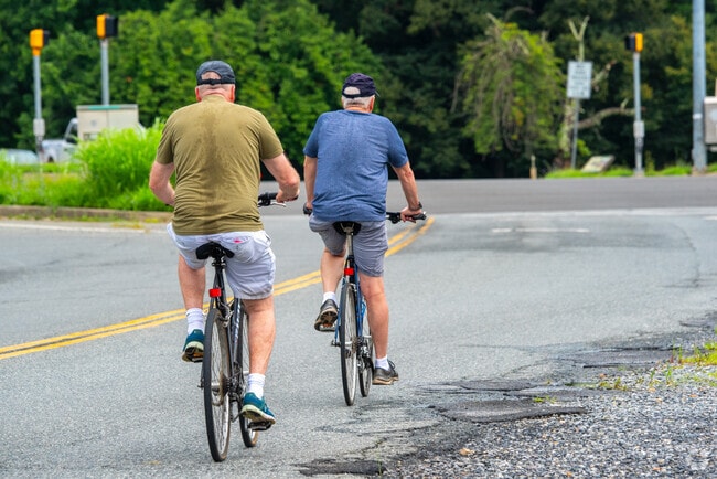 Cyclists ride along Western Avenue, which constitutes the border between Hawthorne and Maryland.