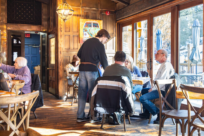 Dine with friends in a cozy, rustic setting at Murphy’s Mountain Grill in Evergreen.