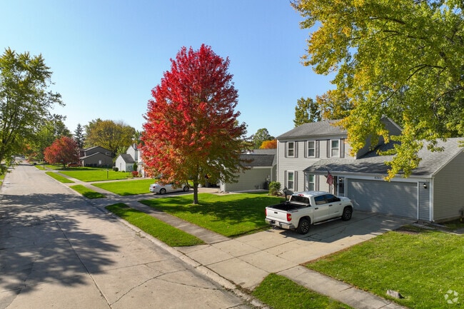 Colorful trees line Old Brook Farm homes in the fall.