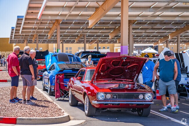 Classic car enthusiasts gather to admire vintage vehicles on display at the Cruiz'n to the Hills Car Show in Estrella Mountain.