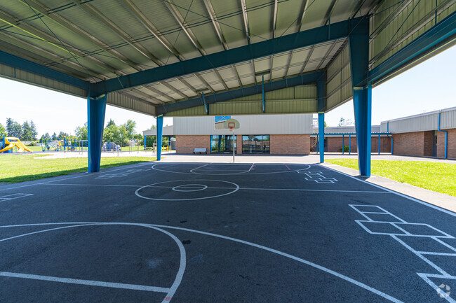 Students can play basketball or hopscotch in the shade at Gubser Elementary School, Keizer, OR.