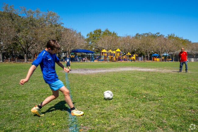 Alcove neighbors play soccer together at Long Center Park.