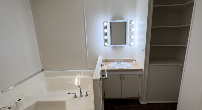 Master with a lot of shelving and a closet.