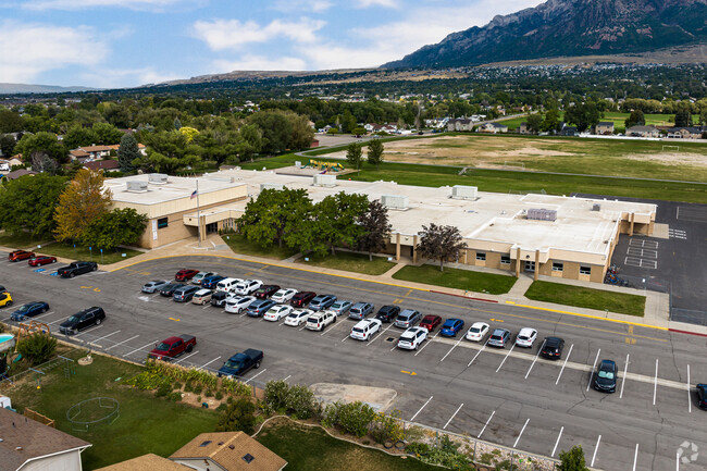 There is a large parking lot in front and a generous field behind Green Acres Elementary School.