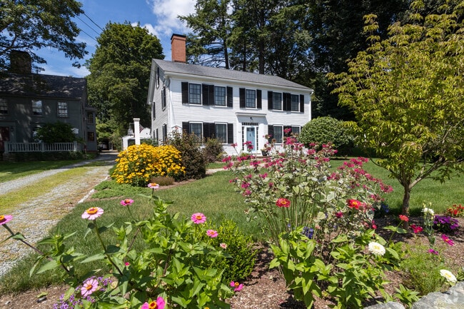 This classic Colonial is nestled among the flowers of Amesbury.
