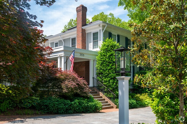 A federal-style home nestled in amongst greenery with a stylish lantern in Cathedral Heights.