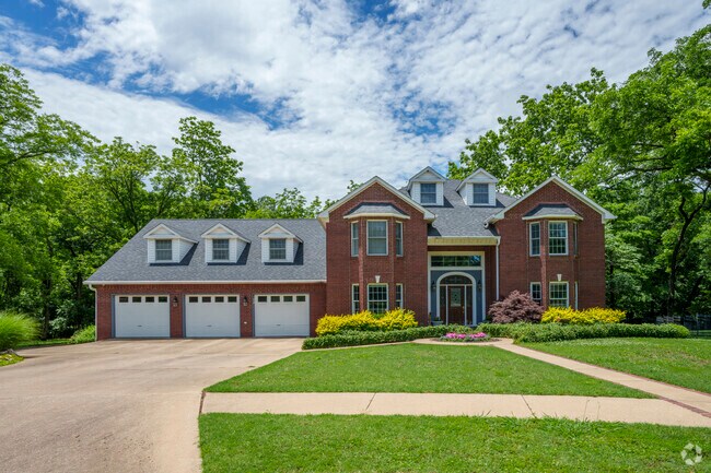 A stately two story brick home sits on a spacious lot in a quiet Pryor Creek neighborhood.