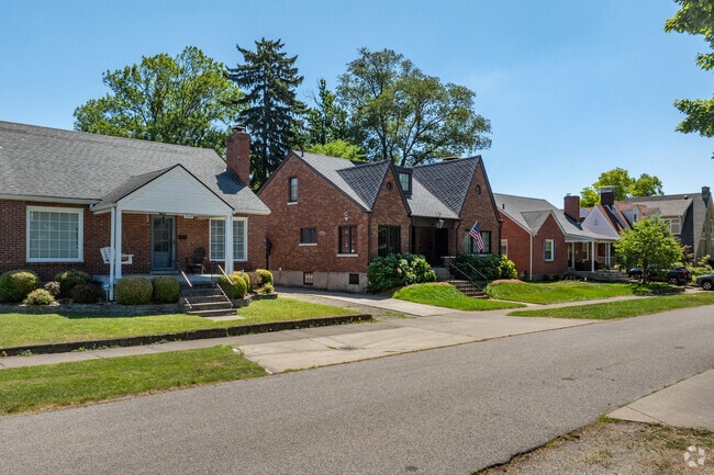 Homes sit close together with sidewalks and off-street parking in Saint Matthews.