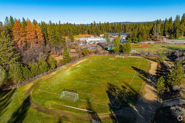 Large green field hosts soccer practice at Colfax Elementary School.