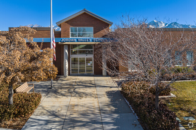 Jordan Valley School has a traditional red brick facade with blue detail.