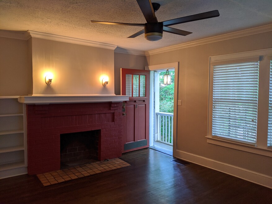 living room non-functional fireplace, staircase landing