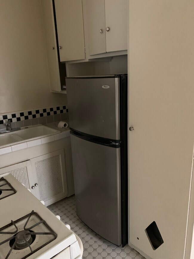 Kitchen with Stove and Refrigerator With Custom Tile Floors