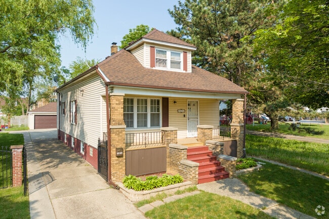 A saltbox-style bungalows sits on a shaded, modest lot in Clayton.
