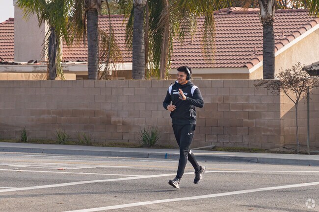 A North Country Meadows jogger waves thanks to a stopped car.