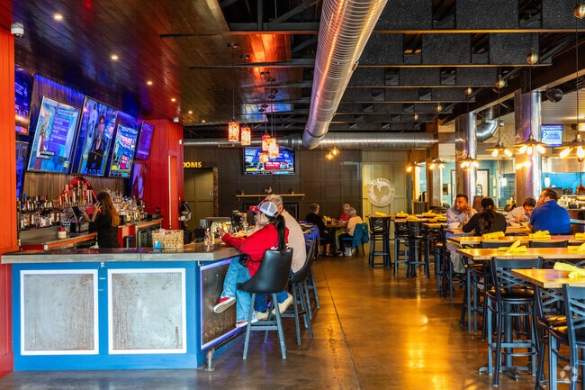 Guests enjoy a delicious meal inside Lucky Rooster Kitchen & Cocktails.