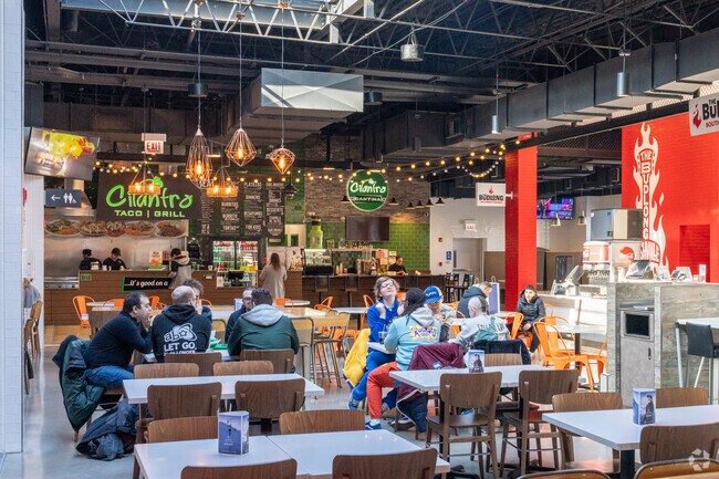 Friends enjoy lunch together at The District Food Hall near Oak Brook.