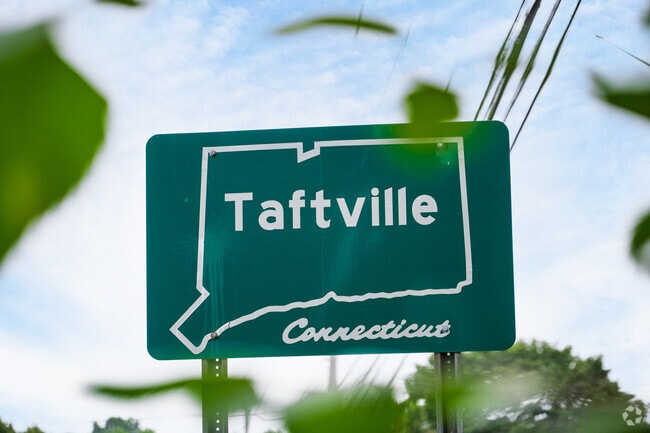 Taftville visitors are greeted with its signage and a suburban feel.