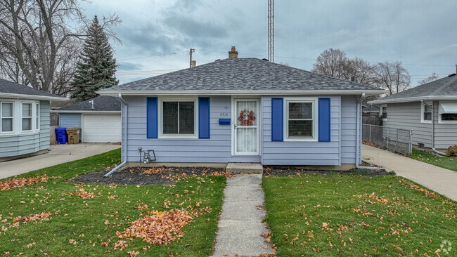 This charming ranch-style home in McKinley features a paved pathway that leads to the door.
