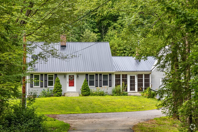 Homes in Belmont include Cape Cod-style houses with private driveways.