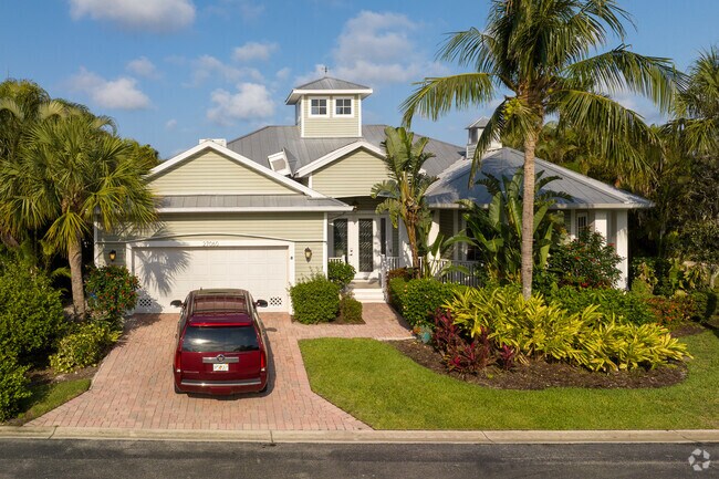 This Florida style contemporary home with lush landscaping can be found in the Imperial Village neighborhood