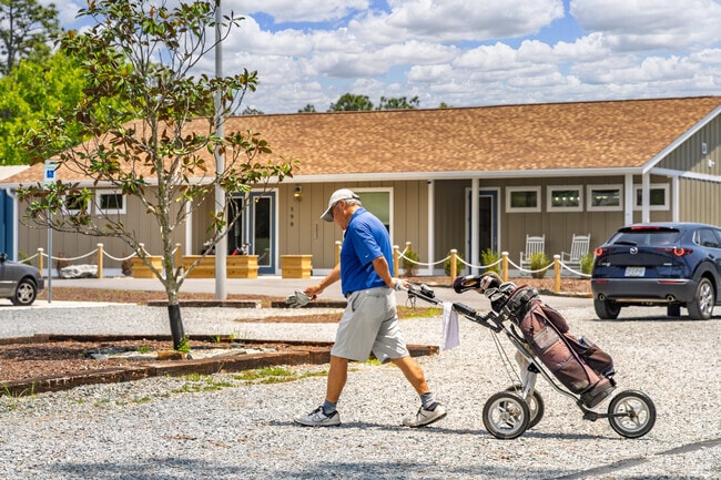 A resident in Boiling Spring Lakes walks toward the course ready for a day of golf.