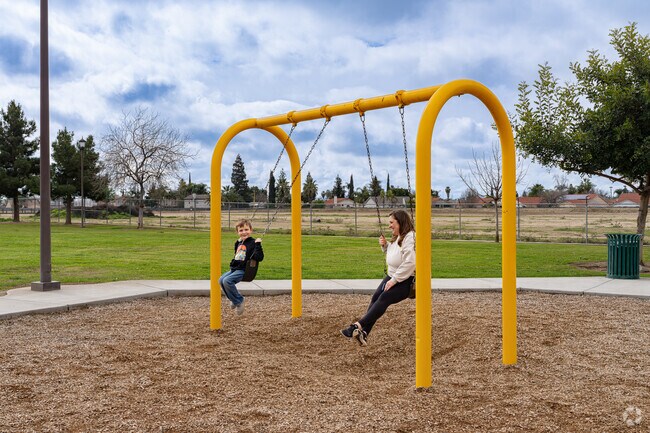 A Calloway Country mother enjoys her time with her son on the swings at Riverlakes Ranch Park.