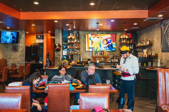 Pineapple village waiter is taking customer's orders of the locals that live in Las Animas.