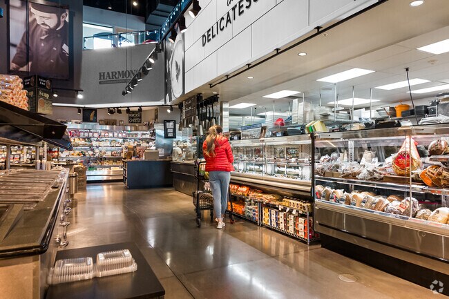A woman checks out the fresh food at Harmon’s in Mount Olympus.