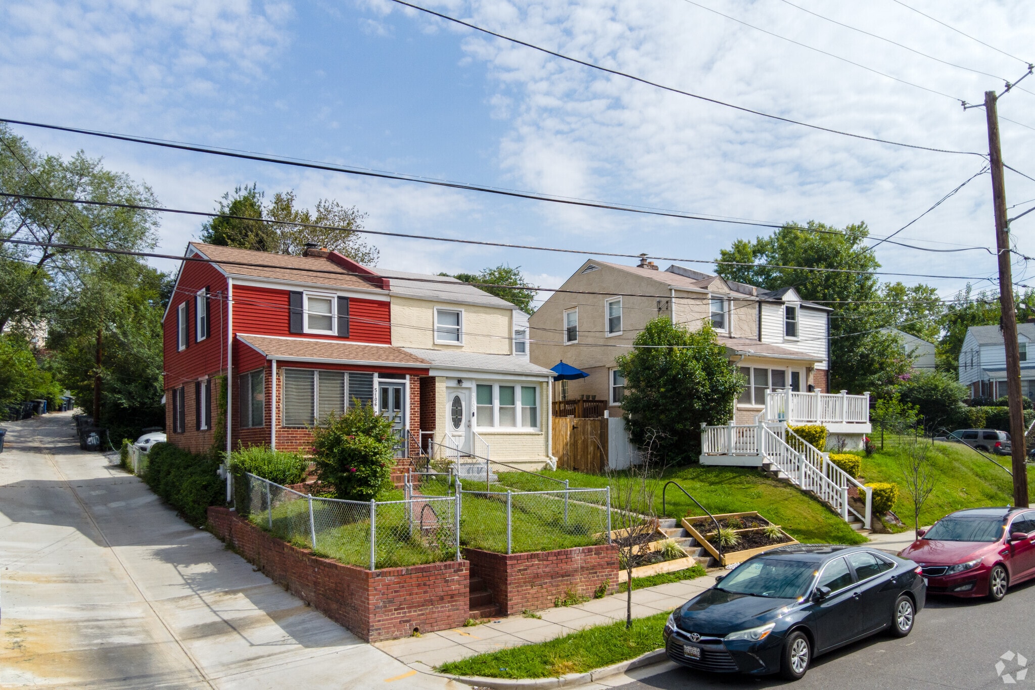Semi-detached row homes in red and yellow on 49th St NE in Hillbrook.