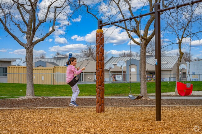 Girl swings high at Blue Oaks Park.