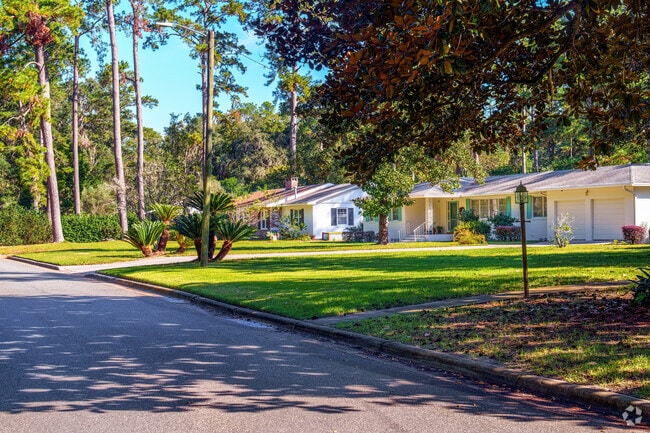 A row of ranch homes in Black Acres features mature trees for added privacy.
