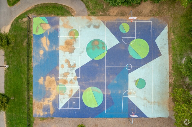Corl Street Elementary School students play on a vast painted blacktop.