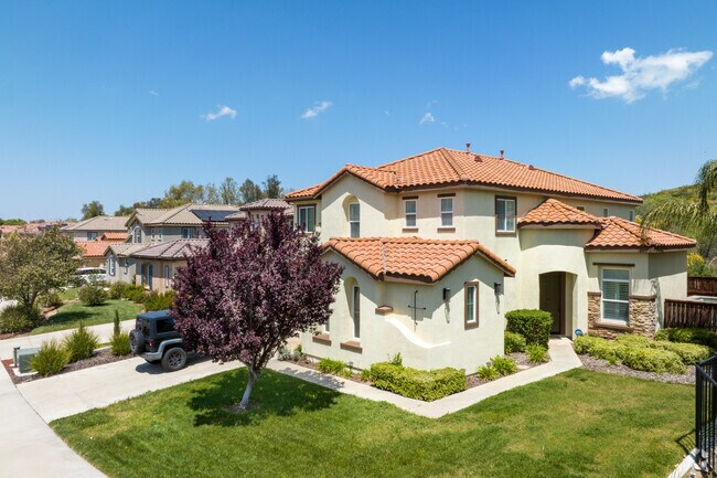 Spanish style home with red tile roof seen in Lakeland Village School in Lakeland Village CA.