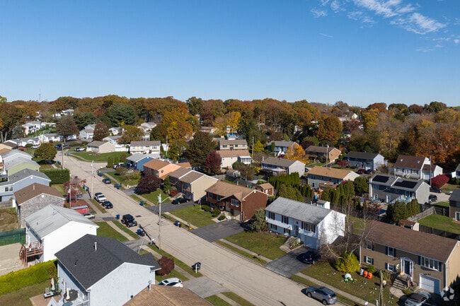 From an aerial perspective, the neighborhood of Greenwood reveals a picturesque row of homes.