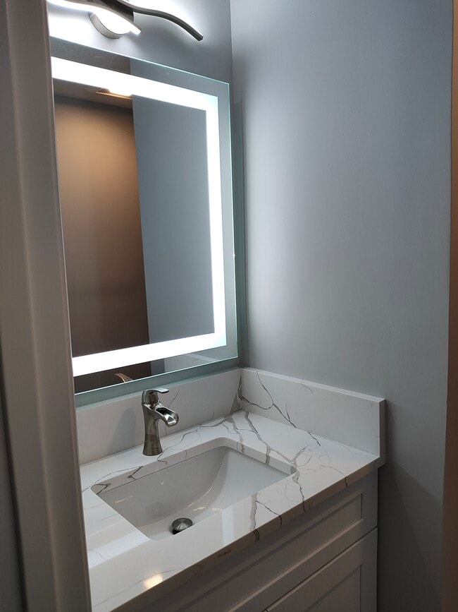 Master Bath Vanity with Calcutta, quartz toner, and LED backlight mirror