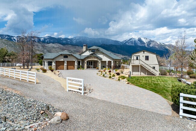 Modern ranch meets mountain elegance with stone accents, barn-style guesthouse, and epic views in Franktown.