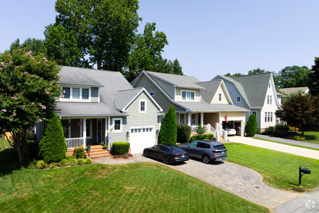 Homes with driveways and well-manicured lawns line the streets of Forest Villa.