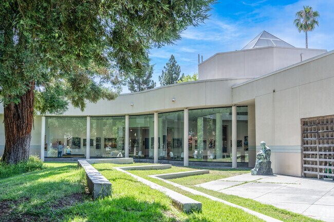 Experience a glass-walled museum that seamlessly blends into a serene garden setting.