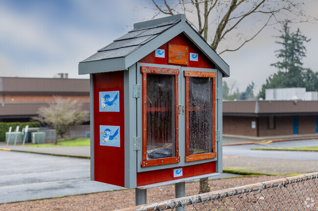 A red little library for sharing with the neighbors at Riverview Elementary School.