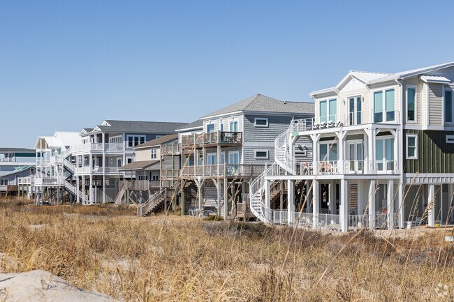 Oak Island has spacious waterfront homes with double porches and coastal styles.