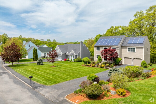 A row of modern and Colonial styled homes in the Bradford Greens neighborhood with some including solar panel updates.