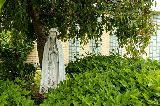 A venerated statue is located in front of the Queen of the Rosary School.